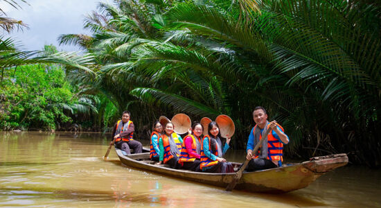 Vibrant Ben Tre orchards in Vietnam for a Ben Tre Tours banner by Legend Travel Group.